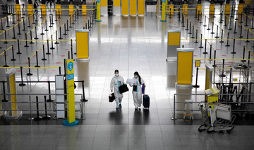 People wearing hazmat suits for protection against COVID-19 walk inside the Ninoy Aquino International Airport in Manila on January 14, 2021. (REUTERS/Eloisa Lopez)