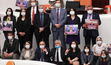 Omer Faruk Gergerlioglu (C), a human rights advocate and lawmaker from the People's Democratic Party (HDP) and his colleagues pose after the parliament stripped his parliamentary seat, in Ankara, on March 17, 2021. (AFP)