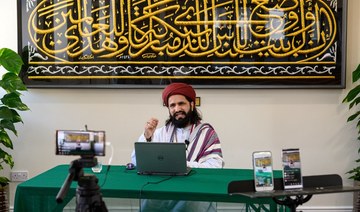 Imam Hassanat Ahmed delivers his Friday broadcast via multiple social media platforms from the otherwise empty Noor Ul Islam Mosque in Bury, Manchester, UK. (AFP)