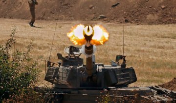 Israeli soldiers fire a 155mm self-propelled howitzer towards the Gaza Strip from their position along the border in the southern Israeli city of Sderot on May 20, 2021. (AFP)