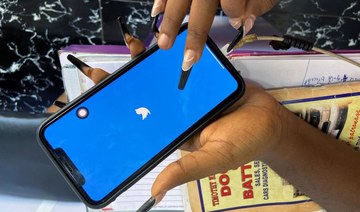 Lagos based entreprenuer Ogechi Egemonu opens the Twitter app on a smart phone at her office in Lagos. (Reuters)