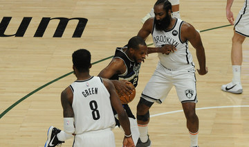 Khris Middleton drives between James Harden (13) and forward Jeff Green (8) during Game 6 of the Bucks-Nets semifinal round playoffs on Thursday. (Michael McLoone-USA TODAY Sports) 