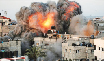 A ball of fire erupts from a building in Gaza City’s Rimal residential district on May 16 during massive Israeli bombardment on the Hamas-controlled enclave. (AFP)