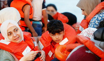 Migrants wait in a boat to be rescued by the crew of the German NGO migrant rescue ship Sea-Watch 3 in international waters off the coast of Libya, in the western Mediterranean Sea, July 30, 2021. (REUTERS)