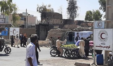 Afghan men walk along a road in Zaranj on August 7, 2021 after Taliban captured their first provincial capital since launching an offensive to coincide with the departure of foreign troops. (AFP)