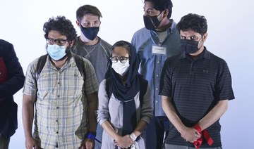 Afghan journalist refugees stand during a welcoming ceremony by Mexican Foreign Minister Marcelo Ebrard upon arrival to Benito Juarez International Airport in Mexico City. (AP)