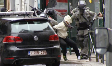 In this Friday March 18, 2016 file framegrab taken from VTM, Salah Abdeslam, centre, is arrested by police and bundled into a police vehicle during a raid in the Molenbeek neighborhood of Brussels, Belgium. (AP)