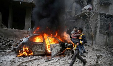 A Syrian Civil Defence member carries a wounded child in the besieged town of Hamoria, Eastern Ghouta, in Damascus, Syria January 6, 2018. (Reuters/File Photo)