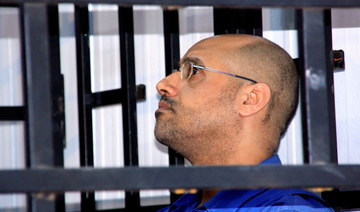 Seif Al-Islam Qaddafi, son of former Libyan leader Muammar, attends a hearing behind bars in a courtroom in Zintan, Libya. (Reuters/File Photo)