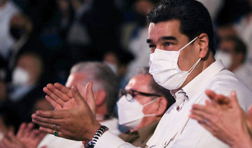 Venezuela's President Nicolas Maduro (R) applauding next to former Cuban President Raul Castro (L) during the inauguration ceremony of the Fidel Castro Ruz Center in Havana, on November 25, 2021. (AFP)