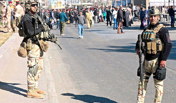 Iraqi security forces stand guard during Friday prayers in Baghdad’s Sadr City district as violence continues to affect several areas of the country. (AFP)