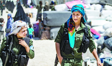 Fighters from the Syrian Democratic Forces patrol inside the Al-Hol camp. (AFP)