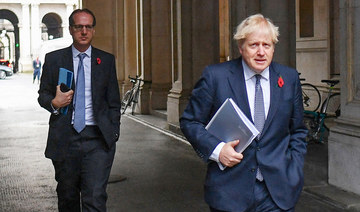 In this file picture taken on November 10, 2020, Britain's Prime Minister Boris Johnson (R) and Martin Reynolds, the Prime Minister's Principal Private Secretary (L), arrive back at Downing Street in London. (AFP)