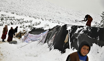 Storm blankets Syrian tented camps in snow, at least one child dead