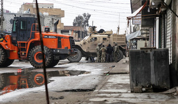 US soldiers accompanied by members of the Syrian Democratic Forces (SDF) gather in the neighbourhood of Ghwayran in the northeastern Syrian city of Hasakeh, on January 29, 2022. (AFP)