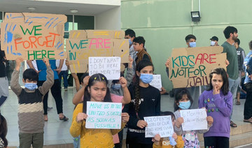 Afghan children hold a rally at a Gulf facility in in Abu Dhabi, United Arab Emirates, to protest the lengthy US relocation process. (Rise to Peace/via REUTERS)