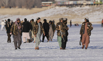 Taliban fighters walk at the frozen Qargha Lake, near Kabul, Afghanistan, in Kabul, Afghanistan, Friday, Feb. 11, 2022. (AP)