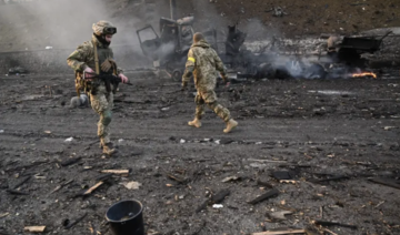 Ukrainian service members look for unexploded shells after a fighting with Russian raiding group in the Ukrainian capital of Kyiv in the morning of February 26, 2022. (AFP)