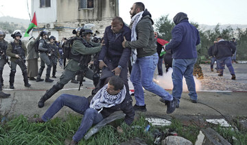 Palestinian protesters scuffles with Israeli security forces during a demonstration against Jewish settlers before tried blocked Palestinian children from entering a school in Nablus, Feb. 27, 2022. (AP)