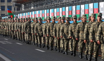 Azeri service members take part in a procession marking the anniversary of the end of the 2020 military conflict over Nagorno-Karabakh breakaway region. (Reuters/File Photo)