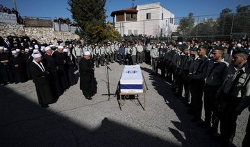 Mourners gather around the flag-draped coffin of Druze Israeli border police officer Yezen Falah, 19, during his funeral in the village of Kisra-Sumei, northern Israel, Monday, March 28, 2022. (AP)