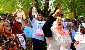  Sudanese protesters rally outside a court in Khartoum on Sunday to support fellow demonstrators. (AFP)