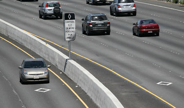 A Toyota Prius with a California "clean air vehicle" sticker drives in the carpool lane on highway 101 in San Rafael, California