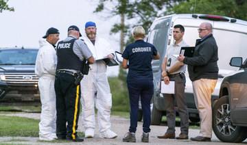 Investigators gather in front of the scene of a stabbing in Weldon, Saskatchewan, Sunday, Sept. 4, 2022. (AP)