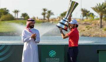 Golf Saudi CEO Noah Alireza hands Abraham Ancer the trophy. (Golf Saudi) 