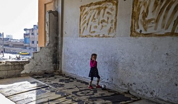 A displaced Syrian child living in war-damaged buildings, is pictured in Syria’s rebel-held northern city of Raqa. (AFP)