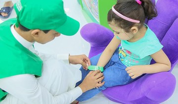 Children given wristbands at Two Holy Mosques 