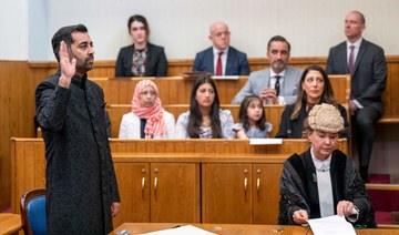 Leader of the Scottish National Party (SNP), Humza Yousaf (L), is sworn in as Scotland's First Minister at the Court of Session.