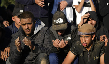 Mourners pray at the grave of Mohammed Al-Osaibi, 26, who was killed by Israeli police in Jerusalem's Old City, at his funeral