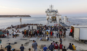 Migrants wait to board an Italian Coast Guard ship in the Sicilian Island of Lampedusa, Italy, Wednesday, Aug. 3, 2022. (AP)