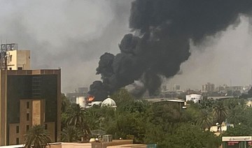 Smoke billows above residential buildings in Khartoum on April 16, 2023. (AFP)