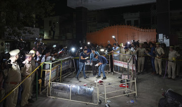 Forensic people inspect the site where politician Atiq Ahmad and his brother Ashraf were shot in Prayagraj, India.