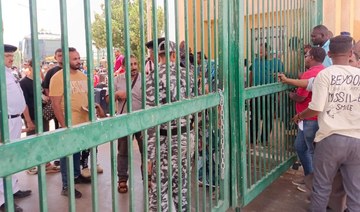 Refugees wait to cross into Egypt through the Argeen land port with Sudan on April 27, 2023. (AFP)