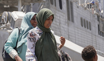 US citizens and other nationalities disembark from a US Navy fast transport ship to escape the conflict, at the Jeddah Sea Port.