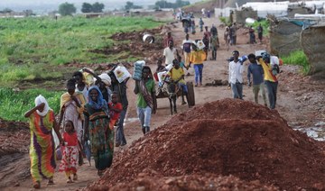 Ethiopian refugees who fled the fighting in the Tigray region transport jerrycans of water at Umm Rakuba camp in eastern Sudan.