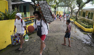 Rains unleashed by typhoon worry thousands of people fleeing restive Philippine volcano