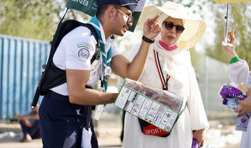 The scouts help pilgrims by guiding them, assisting them, and ensuring that they reach the holy sites or their designated camps.