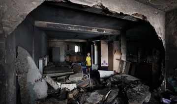 A boy checks the damage inside a house in the occupied West Bank Jenin refugee camp on July 6, 2023. (AFP)