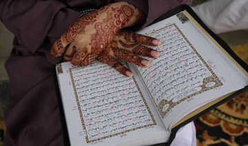 A Muslim woman recites from the Qur’an during a demonstration to denounce the burning of a Qur’an that took place in Sweden.