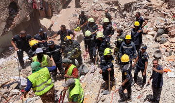 Egyptian emergency and rescue personnel search for survivors in the rubble of a five-story apartment building that collapsed.