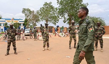 Nigerien soldiers stand guard as supporters of Niger’s CNSP gather for a demonstration in Niamey. (AFP)