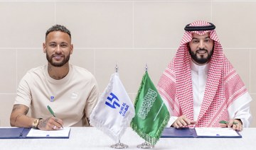 Neymar signs a contract with Chairman of the Board of Directors of Al Hilal, Fahad Bin Saad Bin Nafel, in Paris. AP