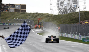 Red Bull’s Max Verstappen passes the chequered flag to win the Dutch Grand Prix. (Reuters)