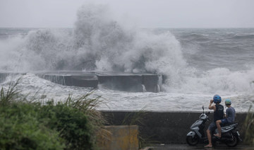 People watch huge waves in Yilan as Typhoon Haikui makes landfall in eastern Taiwan on September 3, 2023. (AFP)