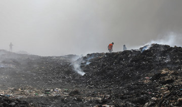 A Palestinian extinguishes a fire at a landfill in Juhr al-Deek, southeast of Gaza City, September 3, 2023. (Reuters)