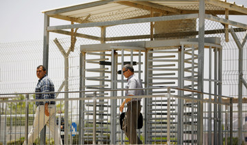 Palestinian men walk through a turnstile on the Israeli side of Erez crossing, on the border with Gaza June 23, 2019. (REUTERS)